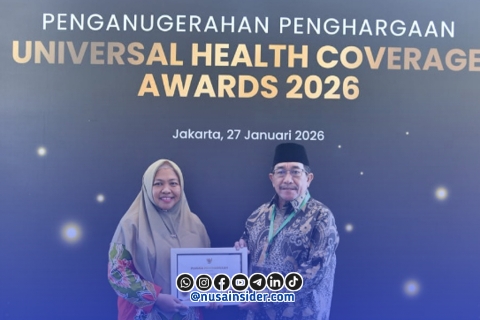 Foto. KH Imam Hasyim (Kanan) Bersama Drg Ellya Fardasah Kepala Dinkes P2KB Sumenep (Kiri) saat menerima penghargaan Nasional UHC